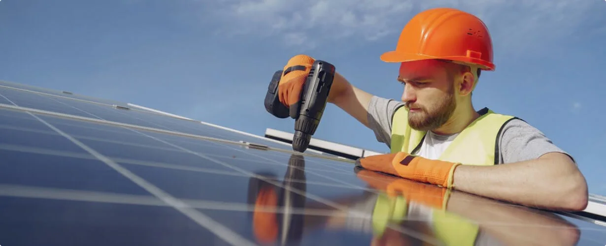 Специалист монтирует солнечные панели